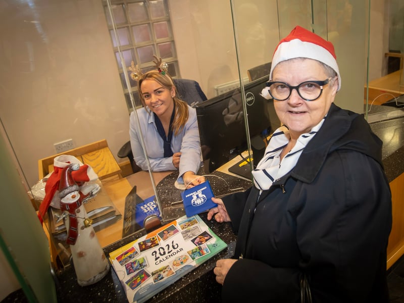 A customer picking up one of the 2026 Derry Credit Union calendars on Saturday.