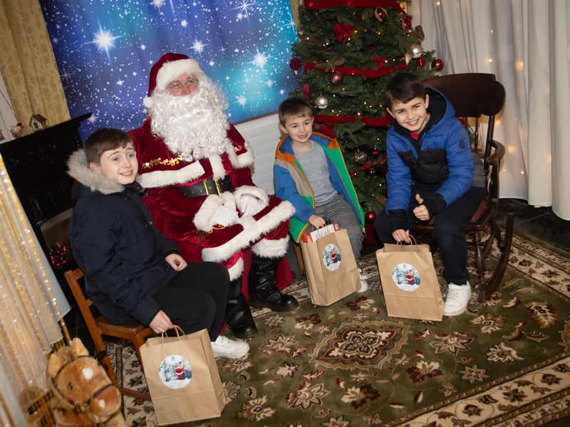 One of the many families getting a photo and collecting a present from Santa on Saturday at Derry Credit Union.