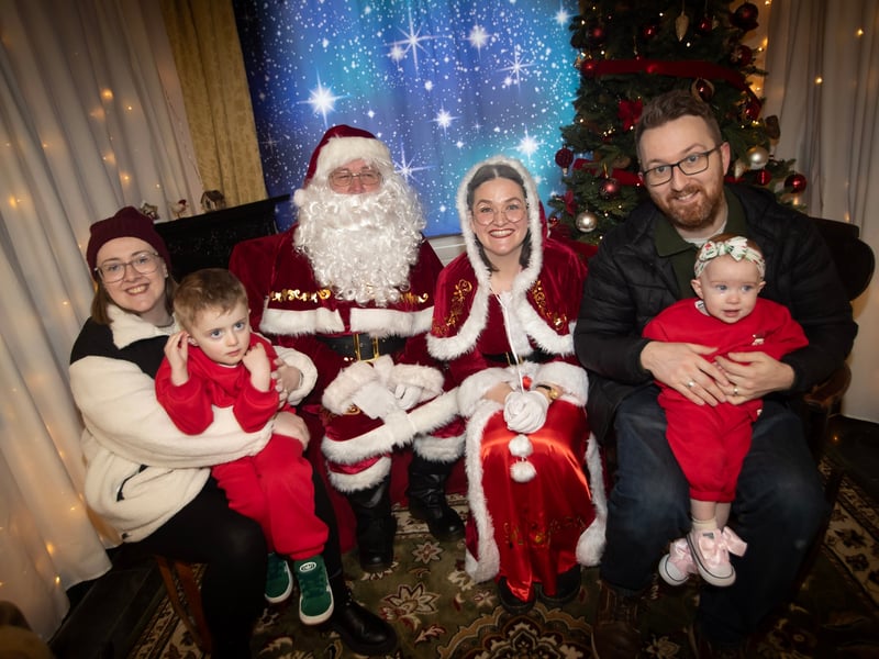 One of the many families getting a photo and collecting a present from Santa on Saturday at Derry Credit Union.