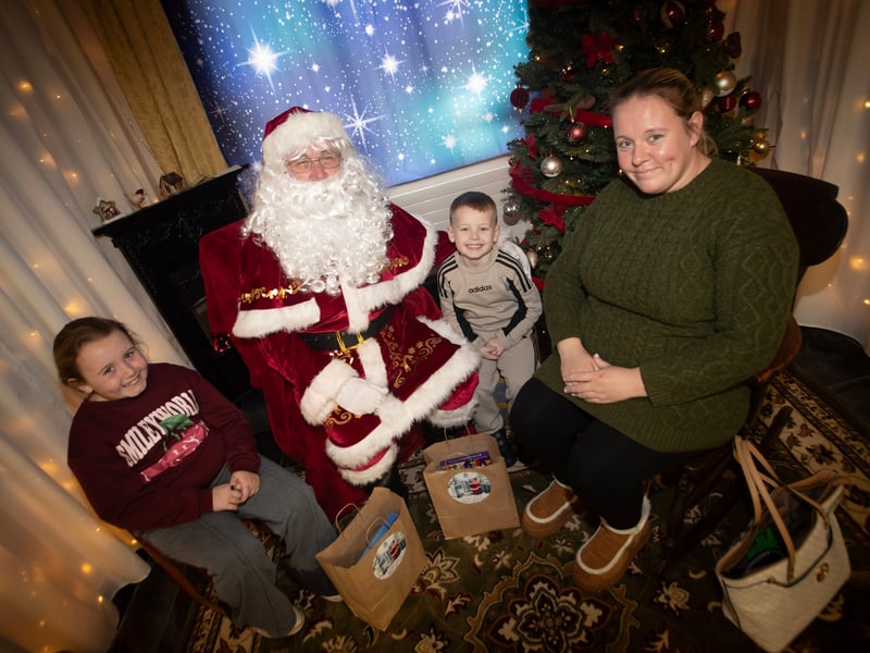 One of the many families getting a photo and collecting a present from Santa on Saturday at Derry Credit Union. (Photos: Jim McCafferty Photography)