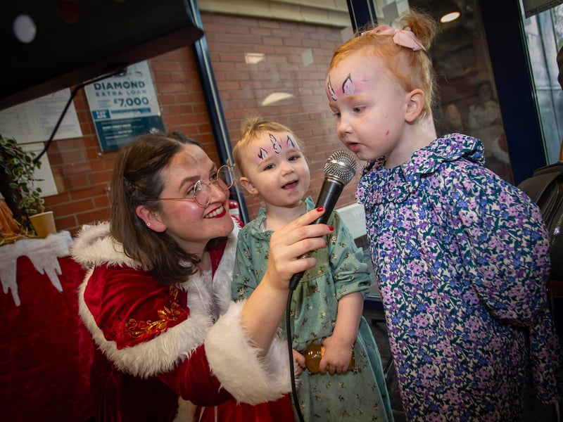 Mrs. Claus singing with some of the younger Derry Credit Union members on Saturday.