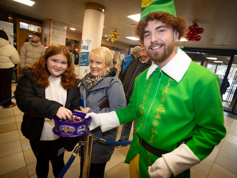 DCU's John Sheering handing out sweets during Santa Saturday at Derry Credit Union..