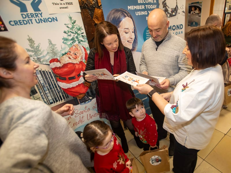 Families checking out the Santa Photos during Saturday's event at the Derry Credit Union.