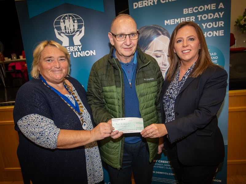 £500 PRIZEWINNER. . . .Mr. John O'Donnell receiving his £500 cheque from Delma Boggs and Sharon Doherty at the Annual General Meeting of, Derry Credit Union on Monday night last.