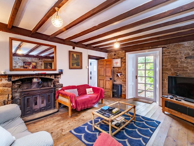 Like something out of The Secret Garden, a stunning period property built near Mountmellick by a historical figure has hit the market for €595,000. Set on 7.7 acres, The 200 year old Mill House promises stunning scenery, a gorgeous apple orchard, wildflower meadows and the ruins of the famous Mountmellick Mill. The Mill House, located in the townland of Drinagh, also known as New Mills, dates back to the early 1800s and carries a remarkable industrial heritage. The earliest records of New Mills appear in 1818, when Joseph Nevitt, noted in Quaker burial archives, resided here and later entered into partnership with John Millner. Together they established a thriving woollen manufacturing business, later expanding into a corn and saw mill. By the mid-1800s, the Millners’ enterprise was well known throughout the region, employing many locals and contributing to the area’s economic development. Elements of the original mill structures still remain on the property today, a lasting testament to the craftsmanship and industrious spirit of that era. Set on approximately 7.7 acres, The Mill House extends to c.214 m² and is surrounded by lavish, mature gardens, an orchard, wild meadow, and beautiful old trees, creating a sense of peace and privacy rarely found. The land is divided into four well-fenced paddocks, making it perfect for livestock or equestrian use thanks to its excellent security and layout. There is also a floodlit arena ideal for night-time riding out, offering superb convenience for horse owners. The current owners have lovingly preserved many of the original features, including stonework, arched brick detailing, and solid timber beams, showcasing the charm and authenticity of this extraordinary home. The accommodation consists of an entrance hall, kitchen cum dining room, living room, sitting room, home office, boot room, laundry, five bedrooms, main bathroom, and guest bathroom. Every room is filled with character, from exposed stone walls to original craftsmanship that reflects the history