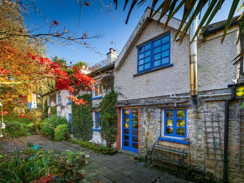 Like something out of The Secret Garden, a stunning period property built near Mountmellick by a historical figure has hit the market for €595,000. Set on 7.7 acres, The 200 year old Mill House promises stunning scenery, a gorgeous apple orchard, wildflower meadows and the ruins of the famous Mountmellick Mill. The Mill House, located in the townland of Drinagh, also known as New Mills, dates back to the early 1800s and carries a remarkable industrial heritage. The earliest records of New Mills appear in 1818, when Joseph Nevitt, noted in Quaker burial archives, resided here and later entered into partnership with John Millner. Together they established a thriving woollen manufacturing business, later expanding into a corn and saw mill. By the mid-1800s, the Millners’ enterprise was well known throughout the region, employing many locals and contributing to the area’s economic development. Elements of the original mill structures still remain on the property today, a lasting testament to the craftsmanship and industrious spirit of that era. Set on approximately 7.7 acres, The Mill House extends to c.214 m² and is surrounded by lavish, mature gardens, an orchard, wild meadow, and beautiful old trees, creating a sense of peace and privacy rarely found. The land is divided into four well-fenced paddocks, making it perfect for livestock or equestrian use thanks to its excellent security and layout. There is also a floodlit arena ideal for night-time riding out, offering superb convenience for horse owners. The current owners have lovingly preserved many of the original features, including stonework, arched brick detailing, and solid timber beams, showcasing the charm and authenticity of this extraordinary home. The accommodation consists of an entrance hall, kitchen cum dining room, living room, sitting room, home office, boot room, laundry, five bedrooms, main bathroom, and guest bathroom. Every room is filled with character, from exposed stone walls to original craftsmanship that reflects the history