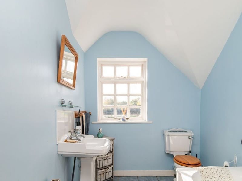 Like something out of The Secret Garden, a stunning period property built near Mountmellick by a historical figure has hit the market for €595,000. Set on 7.7 acres, The 200 year old Mill House promises stunning scenery, a gorgeous apple orchard, wildflower meadows and the ruins of the famous Mountmellick Mill. The Mill House, located in the townland of Drinagh, also known as New Mills, dates back to the early 1800s and carries a remarkable industrial heritage. The earliest records of New Mills appear in 1818, when Joseph Nevitt, noted in Quaker burial archives, resided here and later entered into partnership with John Millner. Together they established a thriving woollen manufacturing business, later expanding into a corn and saw mill. By the mid-1800s, the Millners’ enterprise was well known throughout the region, employing many locals and contributing to the area’s economic development. Elements of the original mill structures still remain on the property today, a lasting testament to the craftsmanship and industrious spirit of that era. Set on approximately 7.7 acres, The Mill House extends to c.214 m² and is surrounded by lavish, mature gardens, an orchard, wild meadow, and beautiful old trees, creating a sense of peace and privacy rarely found. The land is divided into four well-fenced paddocks, making it perfect for livestock or equestrian use thanks to its excellent security and layout. There is also a floodlit arena ideal for night-time riding out, offering superb convenience for horse owners. The current owners have lovingly preserved many of the original features, including stonework, arched brick detailing, and solid timber beams, showcasing the charm and authenticity of this extraordinary home. The accommodation consists of an entrance hall, kitchen cum dining room, living room, sitting room, home office, boot room, laundry, five bedrooms, main bathroom, and guest bathroom. Every room is filled with character, from exposed stone walls to original craftsmanship that reflects the history