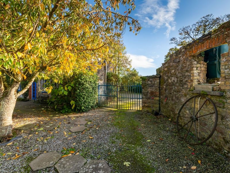 Like something out of The Secret Garden, a stunning period property built near Mountmellick by a historical figure has hit the market for €595,000. Set on 7.7 acres, The 200 year old Mill House promises stunning scenery, a gorgeous apple orchard, wildflower meadows and the ruins of the famous Mountmellick Mill. The Mill House, located in the townland of Drinagh, also known as New Mills, dates back to the early 1800s and carries a remarkable industrial heritage. The earliest records of New Mills appear in 1818, when Joseph Nevitt, noted in Quaker burial archives, resided here and later entered into partnership with John Millner. Together they established a thriving woollen manufacturing business, later expanding into a corn and saw mill. By the mid-1800s, the Millners’ enterprise was well known throughout the region, employing many locals and contributing to the area’s economic development. Elements of the original mill structures still remain on the property today, a lasting testament to the craftsmanship and industrious spirit of that era. Set on approximately 7.7 acres, The Mill House extends to c.214 m² and is surrounded by lavish, mature gardens, an orchard, wild meadow, and beautiful old trees, creating a sense of peace and privacy rarely found. The land is divided into four well-fenced paddocks, making it perfect for livestock or equestrian use thanks to its excellent security and layout. There is also a floodlit arena ideal for night-time riding out, offering superb convenience for horse owners. The current owners have lovingly preserved many of the original features, including stonework, arched brick detailing, and solid timber beams, showcasing the charm and authenticity of this extraordinary home. The accommodation consists of an entrance hall, kitchen cum dining room, living room, sitting room, home office, boot room, laundry, five bedrooms, main bathroom, and guest bathroom. Every room is filled with character, from exposed stone walls to original craftsmanship that reflects the history
