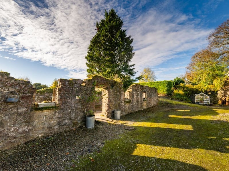 Like something out of The Secret Garden, a stunning period property built near Mountmellick by a historical figure has hit the market for €595,000. Set on 7.7 acres, The 200 year old Mill House promises stunning scenery, a gorgeous apple orchard, wildflower meadows and the ruins of the famous Mountmellick Mill. The Mill House, located in the townland of Drinagh, also known as New Mills, dates back to the early 1800s and carries a remarkable industrial heritage. The earliest records of New Mills appear in 1818, when Joseph Nevitt, noted in Quaker burial archives, resided here and later entered into partnership with John Millner. Together they established a thriving woollen manufacturing business, later expanding into a corn and saw mill. By the mid-1800s, the Millners’ enterprise was well known throughout the region, employing many locals and contributing to the area’s economic development. Elements of the original mill structures still remain on the property today, a lasting testament to the craftsmanship and industrious spirit of that era. Set on approximately 7.7 acres, The Mill House extends to c.214 m² and is surrounded by lavish, mature gardens, an orchard, wild meadow, and beautiful old trees, creating a sense of peace and privacy rarely found. The land is divided into four well-fenced paddocks, making it perfect for livestock or equestrian use thanks to its excellent security and layout. There is also a floodlit arena ideal for night-time riding out, offering superb convenience for horse owners. The current owners have lovingly preserved many of the original features, including stonework, arched brick detailing, and solid timber beams, showcasing the charm and authenticity of this extraordinary home. The accommodation consists of an entrance hall, kitchen cum dining room, living room, sitting room, home office, boot room, laundry, five bedrooms, main bathroom, and guest bathroom. Every room is filled with character, from exposed stone walls to original craftsmanship that reflects the history