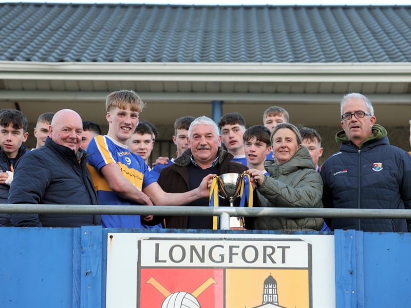 Caption: St Francis Dromard captain William McEntire receives the Glenn Brady Cup from Willie Monaghan & Carmel Brady, with Jimmy Brady and Tommy McLoughlin also in the photograph