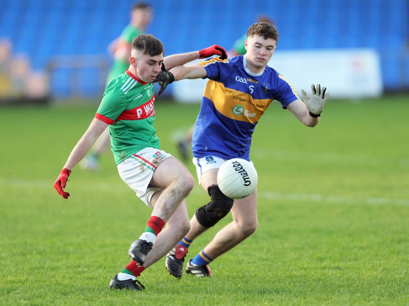 Caption: Keelan Hudson (St Colmcille's) attempts to get his shot away despite the close attention of Adam O'Reilly (St Francis Dromard)