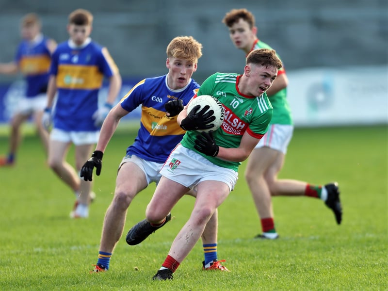 Caption: Steven Martin (St Colmcille's) is tackled by William McEntire (St Francis Dromard)