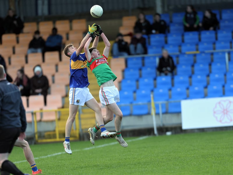 Caption: Daniel Brady (St Colmcille's) and Padraic Mulligan (St Francis Dromard) rise to the clouds in their efforts to win possession during the Glenn Brady Cup Final replay