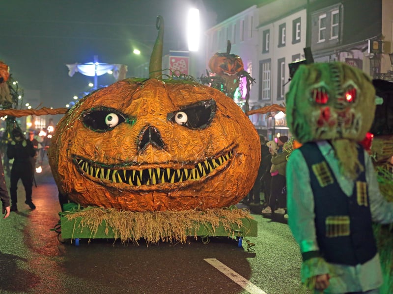 Caption: A giant pumpkin during the spectacular Fire and Shadows Procession, the finale of the 20th Dead of Night Festival