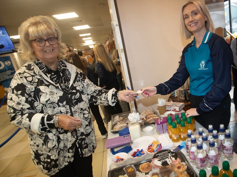 Derry Credit Union member Patricia O'Donnell handing over her ticket for the prize draw to Claire McLaughlin on Saturday, during International Credit Union Day celebrations.