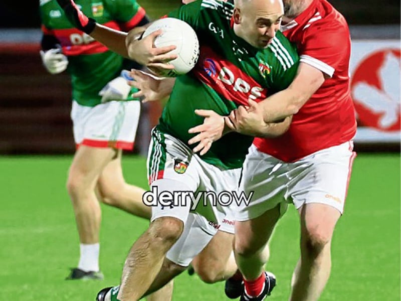 Slaughtmanus Brian Duddy is tackled by Sean Dolans Oran Cassidy in the GAA Junior Reserves Championship final at Celtic Park, on Friday night. (Photos - Tom Heaney, nwpresspics)
