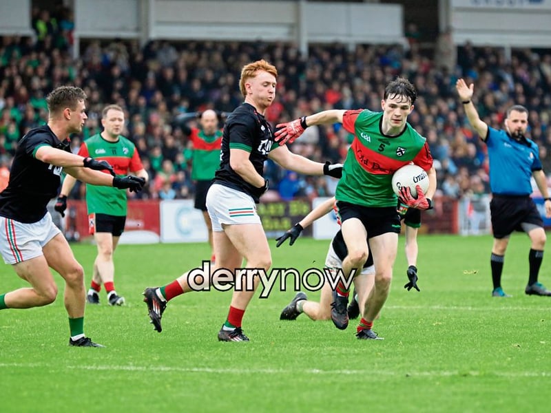 Doire Trasna’s Oran Donnell pulls away from close-encounter with a player.