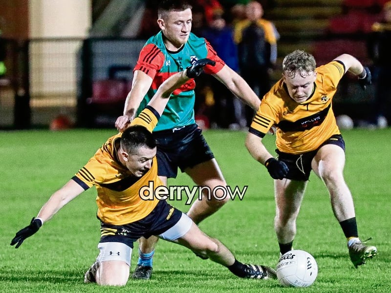 Doire Trasna's and Moneymore players battle for possession in the GAA Junior Football Championship semi-final, on Friday night. (Photos - Tom Heaney, nwpresspics)
