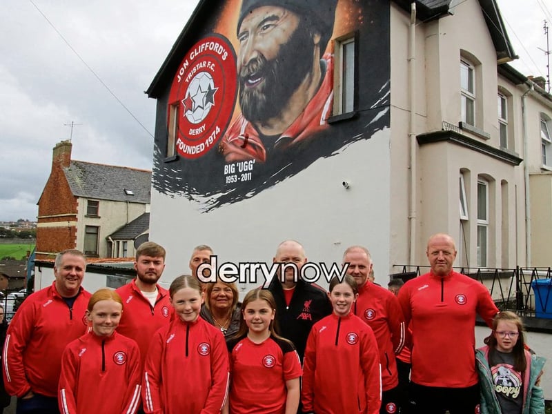 Family members pictured with Tristar Coaches and girls at the official unveiling of the Jon Clifford mural.