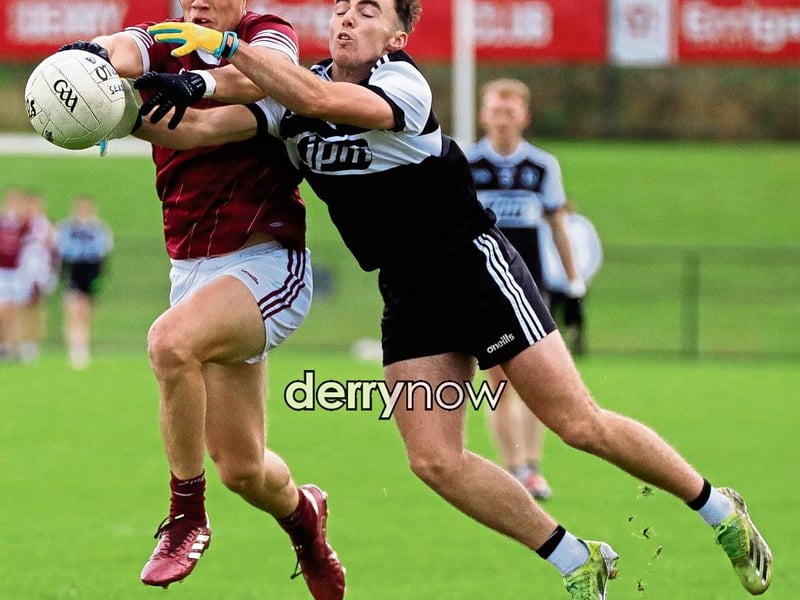 Banagher’s Ruairi Quirk wins this ball in battle against Dungiven’s Eoin McKeever.