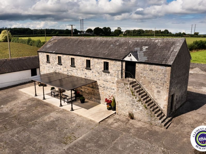 A stunning Georgian property has hit the market in Laois this week. The 19th century Cappakeel House in Emo could be yours, for a cool €1.2 million. Clement Herron Real Estate proudly presents Cappakeel House, a truly exceptional Georgian estate, dating back to circa 1820, situated just moments from the M7 motorway. A striking and private residence positioned on approximately 1.27 hectares (3.14 acres) of lush gardens and pasture, this is a home of rare charm, integrity, and scale. Approached via a tree-lined driveway, the main house immediately commands attention with its perfectly symmetrical Georgian façade, framed by landscaped lawns and mature specimen trees. The property offers the best of both worlds: a timeless period home in pristine condition with carefully preserved original features, and a remarkable opportunity for extensive residential development already granted by planning. The current accommodation spans two floors and includes a charming storm porch leading into an elegant entrance hallway with original Georgian tiled floors, high ceilings, and double doors into the main living spaces. The sitting room and formal dining room sit to either side, both bathed in natural light, feature fireplaces, and ornate coving still in place. To the rear of the house is the kitchen and dining area, a warm and inviting space that leads to a ground floor guest w.c. A standout feature of the home is the broad half-turn staircase which gracefully rises to the first floor. The landing offers a true sense of space and leads to four generously sized bedrooms, each full of character and light, along with the main bathroom, which retains the traditional elegance in keeping with the period style. The home is heated via oil-fired central heating and also benefits from a solid fuel stove for added comfort. The house is in excellent decorative order throughout, with a clear emphasis on preserving the architectural details of the Georgian period while maintaining everyday practicality. The internal spaces feel