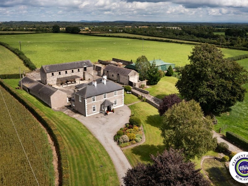 A stunning Georgian property has hit the market in Laois this week. The 19th century Cappakeel House in Emo could be yours, for a cool €1.2 million. Clement Herron Real Estate proudly presents Cappakeel House, a truly exceptional Georgian estate, dating back to circa 1820, situated just moments from the M7 motorway. A striking and private residence positioned on approximately 1.27 hectares (3.14 acres) of lush gardens and pasture, this is a home of rare charm, integrity, and scale. Approached via a tree-lined driveway, the main house immediately commands attention with its perfectly symmetrical Georgian façade, framed by landscaped lawns and mature specimen trees. The property offers the best of both worlds: a timeless period home in pristine condition with carefully preserved original features, and a remarkable opportunity for extensive residential development already granted by planning. The current accommodation spans two floors and includes a charming storm porch leading into an elegant entrance hallway with original Georgian tiled floors, high ceilings, and double doors into the main living spaces. The sitting room and formal dining room sit to either side, both bathed in natural light, feature fireplaces, and ornate coving still in place. To the rear of the house is the kitchen and dining area, a warm and inviting space that leads to a ground floor guest w.c. A standout feature of the home is the broad half-turn staircase which gracefully rises to the first floor. The landing offers a true sense of space and leads to four generously sized bedrooms, each full of character and light, along with the main bathroom, which retains the traditional elegance in keeping with the period style. The home is heated via oil-fired central heating and also benefits from a solid fuel stove for added comfort. The house is in excellent decorative order throughout, with a clear emphasis on preserving the architectural details of the Georgian period while maintaining everyday practicality. The internal spaces feel