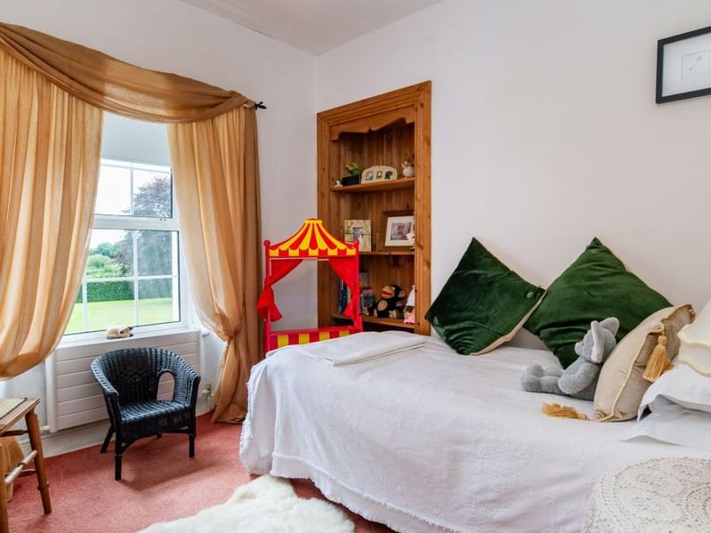 A stunning Georgian property has hit the market in Laois this week. The 19th century Cappakeel House in Emo could be yours, for a cool €1.2 million. Clement Herron Real Estate proudly presents Cappakeel House, a truly exceptional Georgian estate, dating back to circa 1820, situated just moments from the M7 motorway. A striking and private residence positioned on approximately 1.27 hectares (3.14 acres) of lush gardens and pasture, this is a home of rare charm, integrity, and scale. Approached via a tree-lined driveway, the main house immediately commands attention with its perfectly symmetrical Georgian façade, framed by landscaped lawns and mature specimen trees. The property offers the best of both worlds: a timeless period home in pristine condition with carefully preserved original features, and a remarkable opportunity for extensive residential development already granted by planning. The current accommodation spans two floors and includes a charming storm porch leading into an elegant entrance hallway with original Georgian tiled floors, high ceilings, and double doors into the main living spaces. The sitting room and formal dining room sit to either side, both bathed in natural light, feature fireplaces, and ornate coving still in place. To the rear of the house is the kitchen and dining area, a warm and inviting space that leads to a ground floor guest w.c. A standout feature of the home is the broad half-turn staircase which gracefully rises to the first floor. The landing offers a true sense of space and leads to four generously sized bedrooms, each full of character and light, along with the main bathroom, which retains the traditional elegance in keeping with the period style. The home is heated via oil-fired central heating and also benefits from a solid fuel stove for added comfort. The house is in excellent decorative order throughout, with a clear emphasis on preserving the architectural details of the Georgian period while maintaining everyday practicality. The internal spaces feel