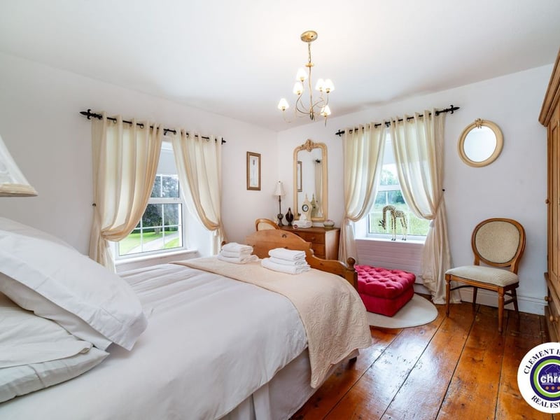 A stunning Georgian property has hit the market in Laois this week. The 19th century Cappakeel House in Emo could be yours, for a cool €1.2 million. Clement Herron Real Estate proudly presents Cappakeel House, a truly exceptional Georgian estate, dating back to circa 1820, situated just moments from the M7 motorway. A striking and private residence positioned on approximately 1.27 hectares (3.14 acres) of lush gardens and pasture, this is a home of rare charm, integrity, and scale. Approached via a tree-lined driveway, the main house immediately commands attention with its perfectly symmetrical Georgian façade, framed by landscaped lawns and mature specimen trees. The property offers the best of both worlds: a timeless period home in pristine condition with carefully preserved original features, and a remarkable opportunity for extensive residential development already granted by planning. The current accommodation spans two floors and includes a charming storm porch leading into an elegant entrance hallway with original Georgian tiled floors, high ceilings, and double doors into the main living spaces. The sitting room and formal dining room sit to either side, both bathed in natural light, feature fireplaces, and ornate coving still in place. To the rear of the house is the kitchen and dining area, a warm and inviting space that leads to a ground floor guest w.c. A standout feature of the home is the broad half-turn staircase which gracefully rises to the first floor. The landing offers a true sense of space and leads to four generously sized bedrooms, each full of character and light, along with the main bathroom, which retains the traditional elegance in keeping with the period style. The home is heated via oil-fired central heating and also benefits from a solid fuel stove for added comfort. The house is in excellent decorative order throughout, with a clear emphasis on preserving the architectural details of the Georgian period while maintaining everyday practicality. The internal spaces feel