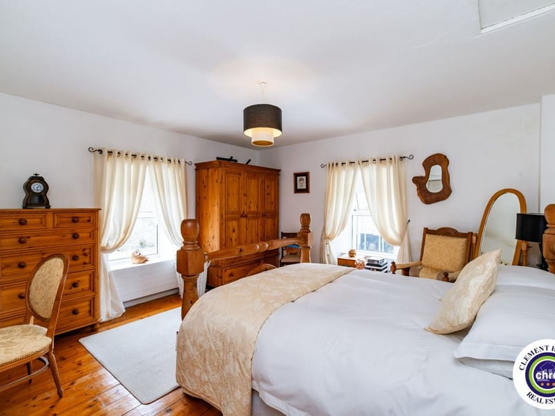 A stunning Georgian property has hit the market in Laois this week. The 19th century Cappakeel House in Emo could be yours, for a cool €1.2 million. Clement Herron Real Estate proudly presents Cappakeel House, a truly exceptional Georgian estate, dating back to circa 1820, situated just moments from the M7 motorway. A striking and private residence positioned on approximately 1.27 hectares (3.14 acres) of lush gardens and pasture, this is a home of rare charm, integrity, and scale. Approached via a tree-lined driveway, the main house immediately commands attention with its perfectly symmetrical Georgian façade, framed by landscaped lawns and mature specimen trees. The property offers the best of both worlds: a timeless period home in pristine condition with carefully preserved original features, and a remarkable opportunity for extensive residential development already granted by planning. The current accommodation spans two floors and includes a charming storm porch leading into an elegant entrance hallway with original Georgian tiled floors, high ceilings, and double doors into the main living spaces. The sitting room and formal dining room sit to either side, both bathed in natural light, feature fireplaces, and ornate coving still in place. To the rear of the house is the kitchen and dining area, a warm and inviting space that leads to a ground floor guest w.c. A standout feature of the home is the broad half-turn staircase which gracefully rises to the first floor. The landing offers a true sense of space and leads to four generously sized bedrooms, each full of character and light, along with the main bathroom, which retains the traditional elegance in keeping with the period style. The home is heated via oil-fired central heating and also benefits from a solid fuel stove for added comfort. The house is in excellent decorative order throughout, with a clear emphasis on preserving the architectural details of the Georgian period while maintaining everyday practicality. The internal spaces feel