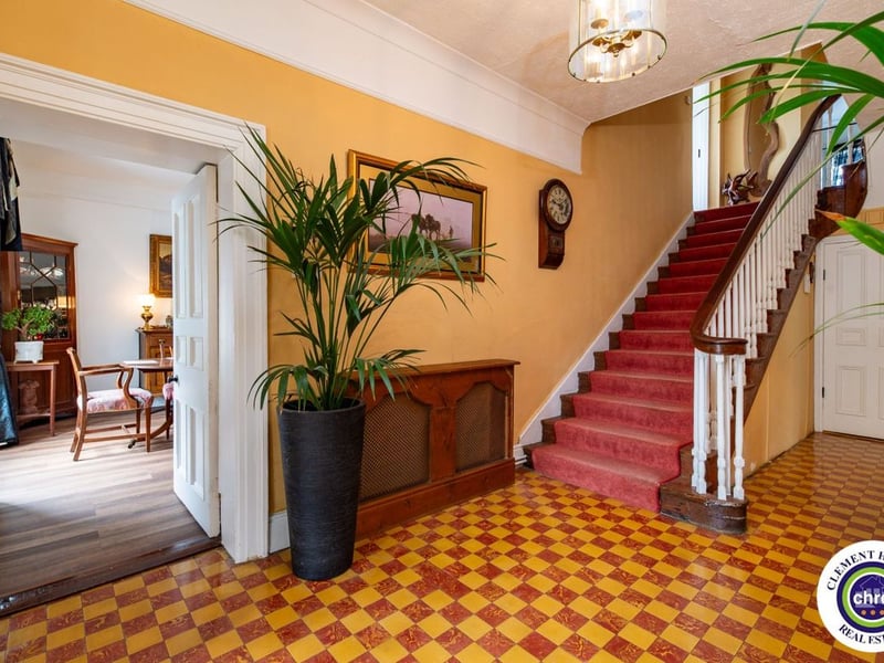 A stunning Georgian property has hit the market in Laois this week. The 19th century Cappakeel House in Emo could be yours, for a cool €1.2 million. Clement Herron Real Estate proudly presents Cappakeel House, a truly exceptional Georgian estate, dating back to circa 1820, situated just moments from the M7 motorway. A striking and private residence positioned on approximately 1.27 hectares (3.14 acres) of lush gardens and pasture, this is a home of rare charm, integrity, and scale. Approached via a tree-lined driveway, the main house immediately commands attention with its perfectly symmetrical Georgian façade, framed by landscaped lawns and mature specimen trees. The property offers the best of both worlds: a timeless period home in pristine condition with carefully preserved original features, and a remarkable opportunity for extensive residential development already granted by planning. The current accommodation spans two floors and includes a charming storm porch leading into an elegant entrance hallway with original Georgian tiled floors, high ceilings, and double doors into the main living spaces. The sitting room and formal dining room sit to either side, both bathed in natural light, feature fireplaces, and ornate coving still in place. To the rear of the house is the kitchen and dining area, a warm and inviting space that leads to a ground floor guest w.c. A standout feature of the home is the broad half-turn staircase which gracefully rises to the first floor. The landing offers a true sense of space and leads to four generously sized bedrooms, each full of character and light, along with the main bathroom, which retains the traditional elegance in keeping with the period style. The home is heated via oil-fired central heating and also benefits from a solid fuel stove for added comfort. The house is in excellent decorative order throughout, with a clear emphasis on preserving the architectural details of the Georgian period while maintaining everyday practicality. The internal spaces feel