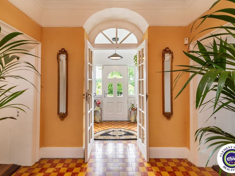 A stunning Georgian property has hit the market in Laois this week. The 19th century Cappakeel House in Emo could be yours, for a cool €1.2 million. Clement Herron Real Estate proudly presents Cappakeel House, a truly exceptional Georgian estate, dating back to circa 1820, situated just moments from the M7 motorway. A striking and private residence positioned on approximately 1.27 hectares (3.14 acres) of lush gardens and pasture, this is a home of rare charm, integrity, and scale. Approached via a tree-lined driveway, the main house immediately commands attention with its perfectly symmetrical Georgian façade, framed by landscaped lawns and mature specimen trees. The property offers the best of both worlds: a timeless period home in pristine condition with carefully preserved original features, and a remarkable opportunity for extensive residential development already granted by planning. The current accommodation spans two floors and includes a charming storm porch leading into an elegant entrance hallway with original Georgian tiled floors, high ceilings, and double doors into the main living spaces. The sitting room and formal dining room sit to either side, both bathed in natural light, feature fireplaces, and ornate coving still in place. To the rear of the house is the kitchen and dining area, a warm and inviting space that leads to a ground floor guest w.c. A standout feature of the home is the broad half-turn staircase which gracefully rises to the first floor. The landing offers a true sense of space and leads to four generously sized bedrooms, each full of character and light, along with the main bathroom, which retains the traditional elegance in keeping with the period style. The home is heated via oil-fired central heating and also benefits from a solid fuel stove for added comfort. The house is in excellent decorative order throughout, with a clear emphasis on preserving the architectural details of the Georgian period while maintaining everyday practicality. The internal spaces feel