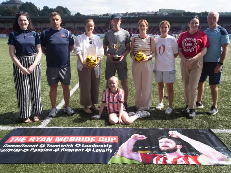 RYAN McBRIDE CUP 2025. . .Group pictured at the Ryan McBride Brandywell Stadium on a sunny Thursday afternoon for the start of the Feile's Annual Ryan McBride Cup. From left, Ciara McElhinney, BBHF, Mo Mahon, tournament organiser, Colleen mcCann, Ryan's sister, Lexie McBride, Ryan's father, Siunin McBride, Gina McBride, Ryan's sisters, Aisling Hutton and George Harkin, BBHF.