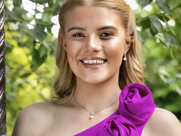 Cork Rose - Nancy Lehane My name is Nancy Lehane, and I’m honoured to be the 2025 Cork Rose. I’m 22 years old and proudly from Meelin, the highest village in Ireland. I recently completed my degree in primary school teaching. Teaching has always been part of who I am. I began teaching music to children and adults at fourteen and continued until I was seventeen. Even now, I am often teaching my four brothers how to hang clothes on the line properly — so teaching was definitely the path for me! Teaching children was always a dream of mine. Music has been a huge part of my life since the age of five. I play the guitar, piano, concertina, and tin whistle, and I love to sing. I’ve shared my music at community events and through volunteering, and I’m passionate about using it to bring joy to others. I also love sport and play Gaelic football with my local club. I enjoy the craic, teamwork, and fitness it brings. I’m so grateful and excited for the journey ahead as the 2025 Cork Rose.