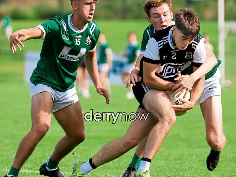 Dungiven's Shea McAteer presses forward despite the efforts of Newbridge players to stop his advance. (Photos - Tom Heaney, nwpresspics)