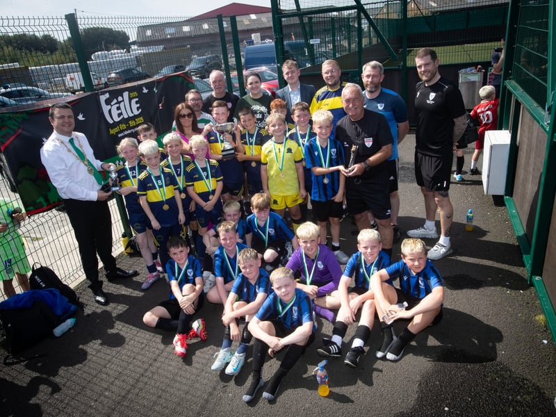 PADRAIG BARTON CUP WINNERS. . . .The Mayor of Derry City and Strabane District Council, Ruairi McHugh and members of the late Padraig Barton were on hand to present trophies to the winners of this year's Feile '25 tournament to Don Boscos. At front are beaten finalists Oxford United and included are match officials, organisers and local councillors and MLAs. (Photos: Jim McCafferty Photography)