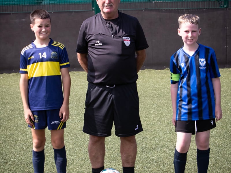 Padraig Barton Cup final referee Martin Dunne with the captains of Don Boscos and Oxford on Tuesday.