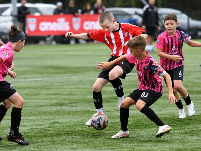 Tristar Colts under-11's player Shay Boyle battles with a packed Patruno FP (USA) midfield at the Vale Centre.