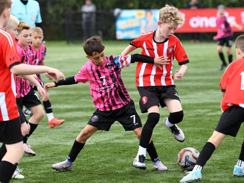 Patruno FB (USA) under-11's player Adrian Anderson battles for the ball with Tristar Colts midfielder Caden Hegarty at the Vale Centre.