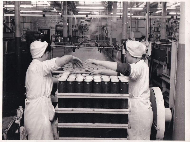 Mary Herron (nee McDaid) from Carndonagh (on left) with her Scottish friend and co-worker Madge Byrnes stacking filled jam jars onto a pallet at the Robertson’s Jam factory in Paisley. The jam jars were washed in cold water to cool them for handling and they would lift four jars at a time. (Image courtesy of Mary Herron)