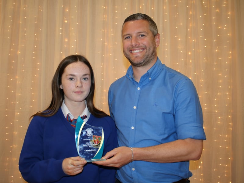 Below: Aaron Comerford presents The Julia Magee Perpetual Trophy for History to Caoimhe Dooley