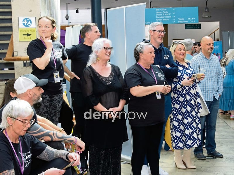 Group pictured enjoying listening to The Hive Choir as they perform at the event.