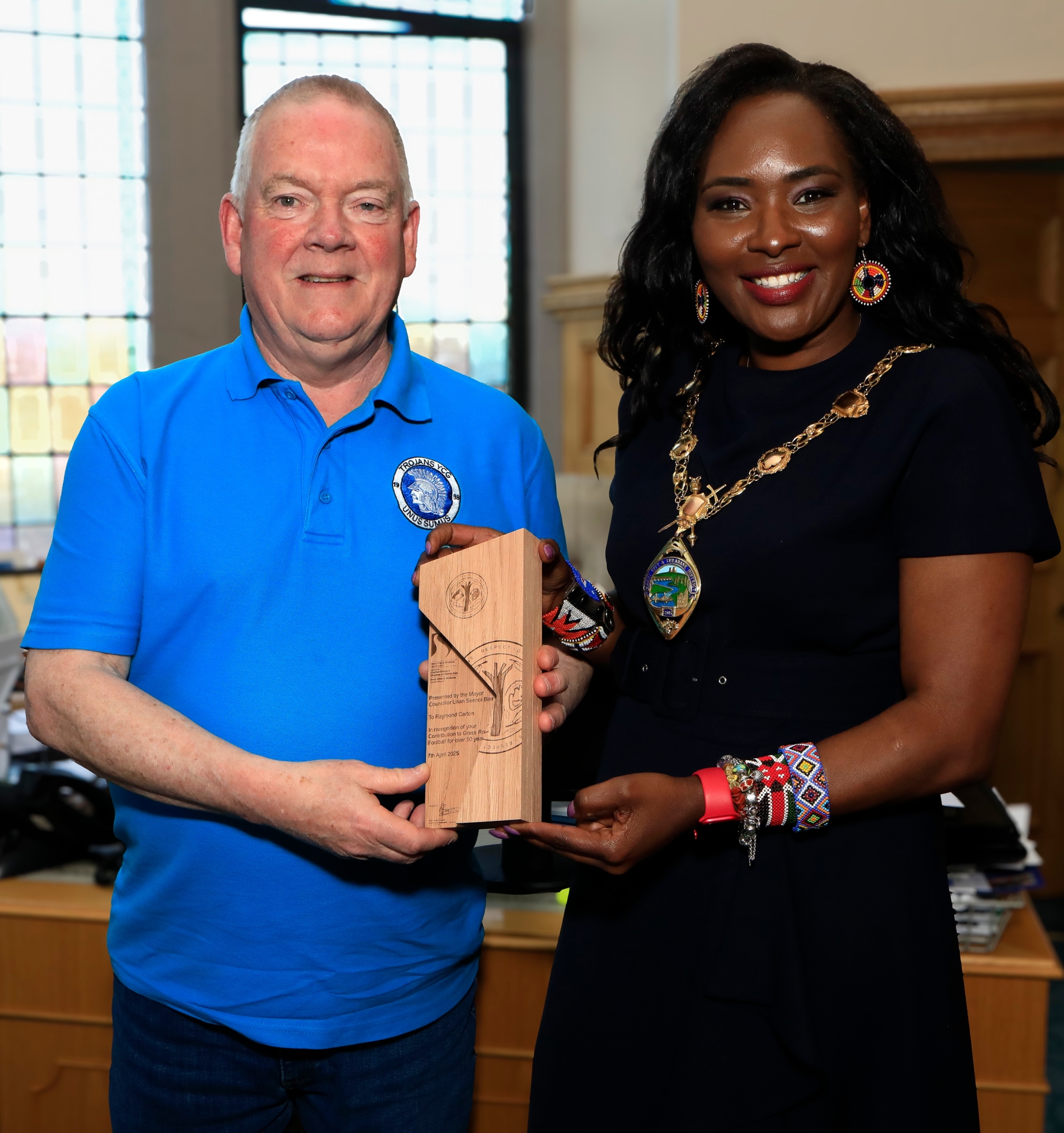 Mayor Lilian Seenoi Barr makes a presentation to Trojans FC vice-president Raymond Carton, in recognition of his contribution to Grass Roots Football for over 50 years, at a reception held in the Mayor's Parlour. (Photos - Tom Heaney, nwpresspics)