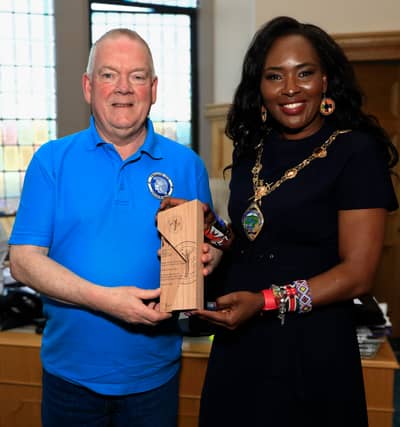 Mayor Lilian Seenoi Barr makes a presentation to Trojans FC vice-president Raymond Carton, in recognition of his contribution to Grass Roots Football for over 50 years, at a reception held in the Mayor's Parlour. (Photos - Tom Heaney, nwpresspics)