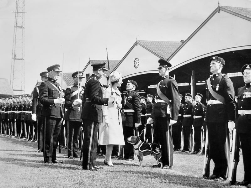 Escorted by three regimental colonels bearing drawn swords, Her Majesty Queen Elizabeth II inspects members of the 5/6th Battalion, The North Staffordshire Regiment, on May 24, 1962. The grand military parade took place on the pitch at Molineux, home of Wolverhampton Wanderers. Standing proudly alongside the troops on the turf was the unit's official mascot—a tan and white Staffordshire bull terrier named Watchman II, who received a special glance from the monarch during her walk-past. Were you among the crowds packing out the Molineux stands to catch a glimpse of the Queen and Watchman II in May 1962?