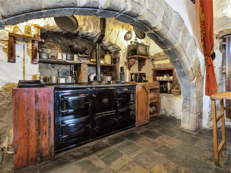 Just off the Great Hall, the kitchen continues the castle’s theme of rustic elegance. 