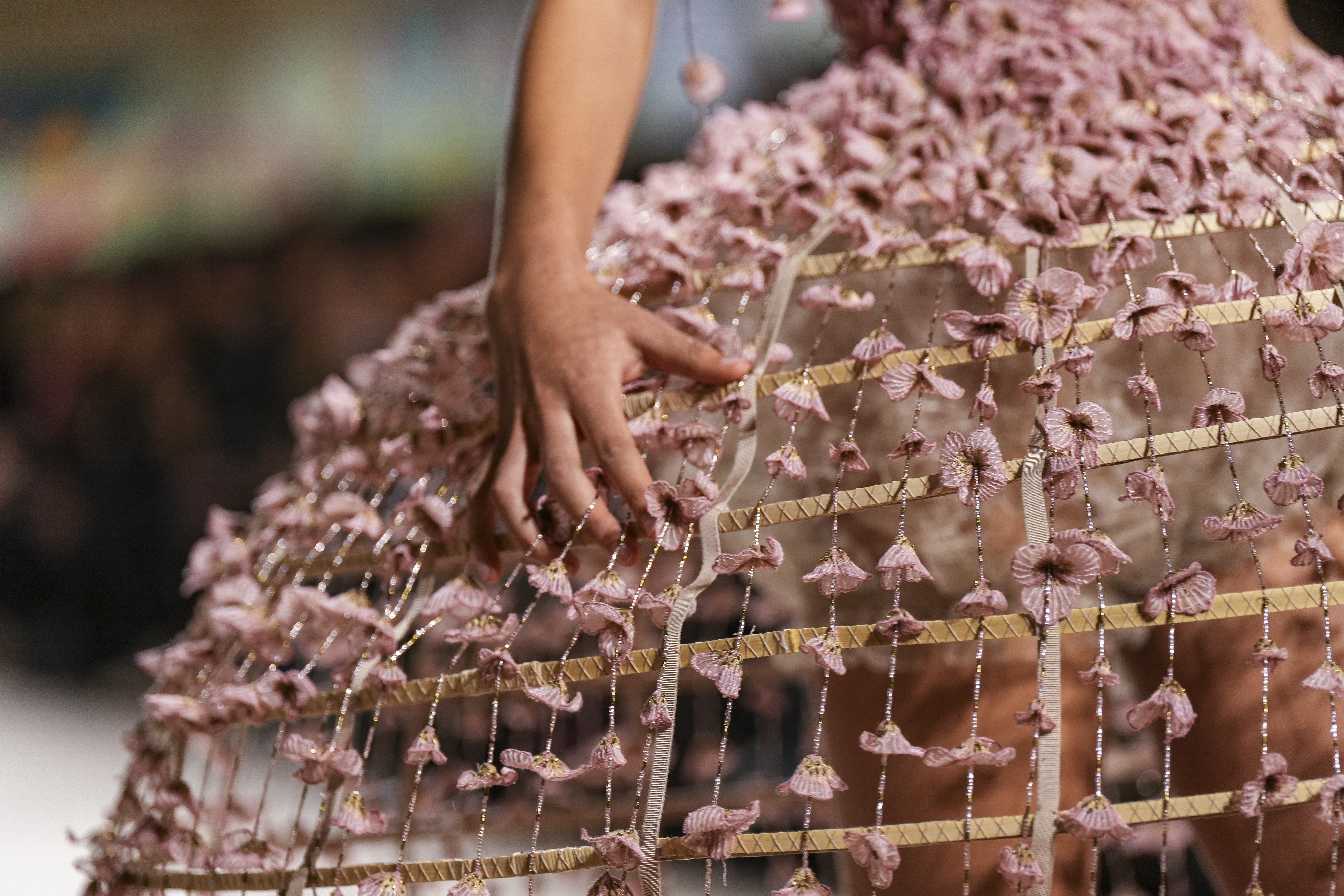 Chuiri’s use of ​​transparent organza, broderie anglaise and lace attached to cage-like crinolines with streaming ribbons showcased a naïve rawness – as if the models had been caught playing dress up.