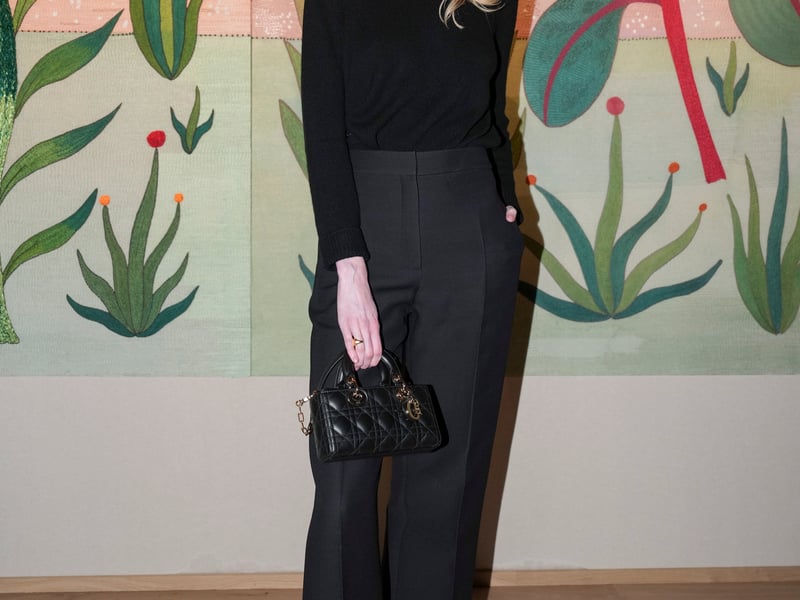 The Crown star Elizabeth Debicki, 34, kept it simple in all-black, with sharp suit trouser, pointed kitten heels and a quilted Lady D-Joy micro.