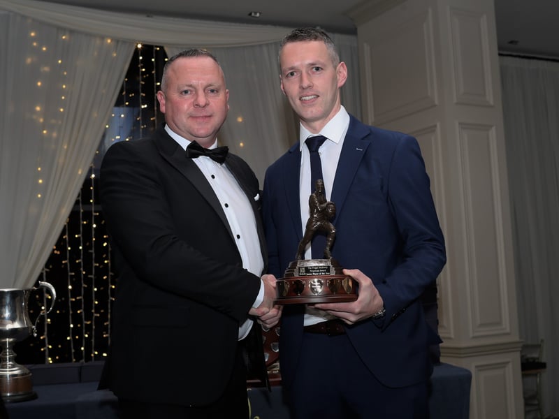 Caption:  Martin Mulleady presents the Fergal Mulleady memorial trophy to the junior player of the year Declan Donnelly. Photo: Syl Healy.