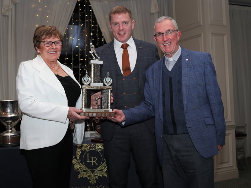 Caption: Eileen Kerrigan and Fr. Tully present the Eamon Kerrigan memorial trophy to Cian Brady, the senior player of the year 2023 . Photo: Syl Healy.