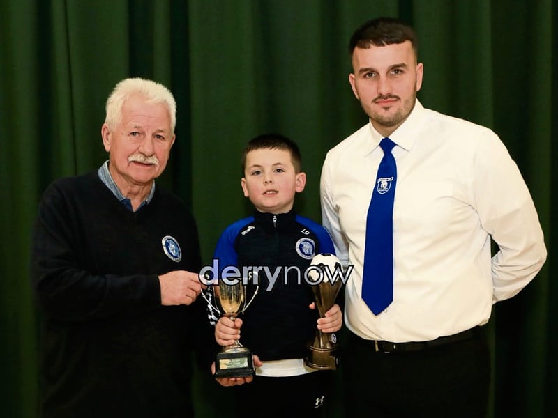 Paddy McLaren presents Logan Duffy the Young Clubman of the Year Award at the Trojans Youth & Community Group annual Youth Presentation of Awards held in St. Cecilia’s College. Included is Diolain Ward.
